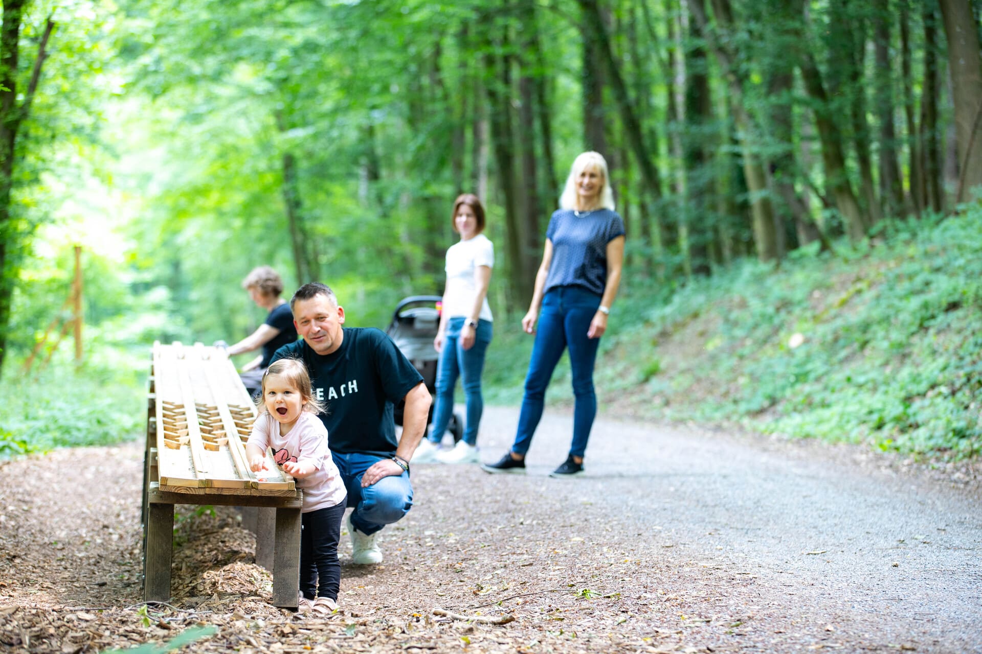 Familie an der Murmelbahn im Wald auf dem Komfort-Wanderweg 6